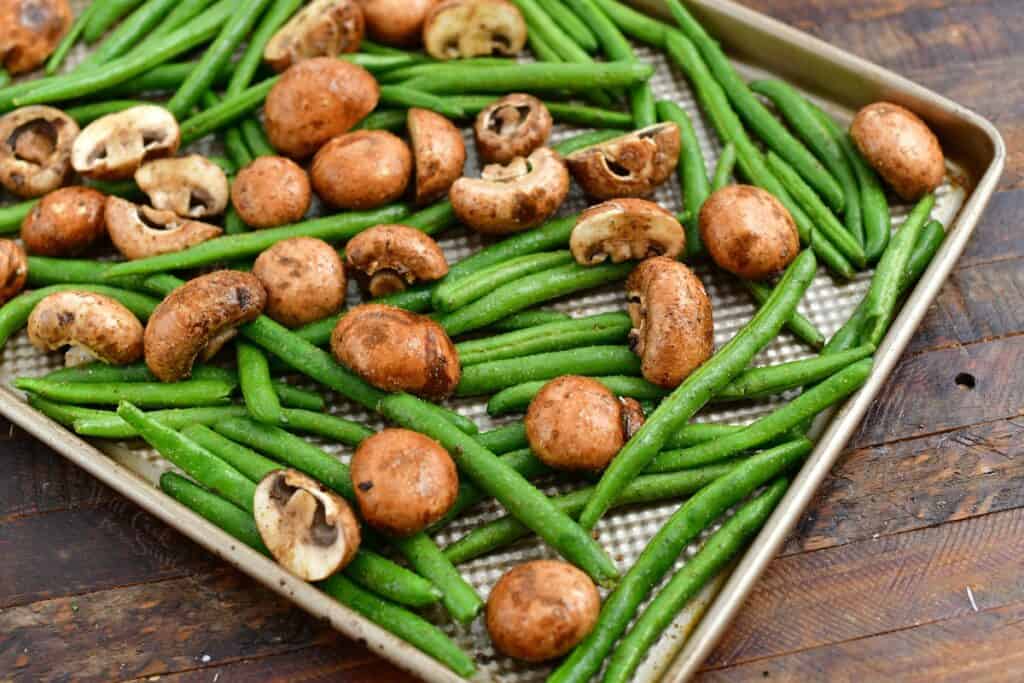 raw mushrooms and fresh green beans for making a roasted vegetables recipe