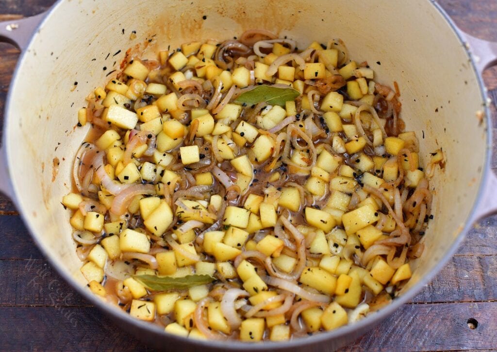 sauteed diced vegetables in bottom of a white pot