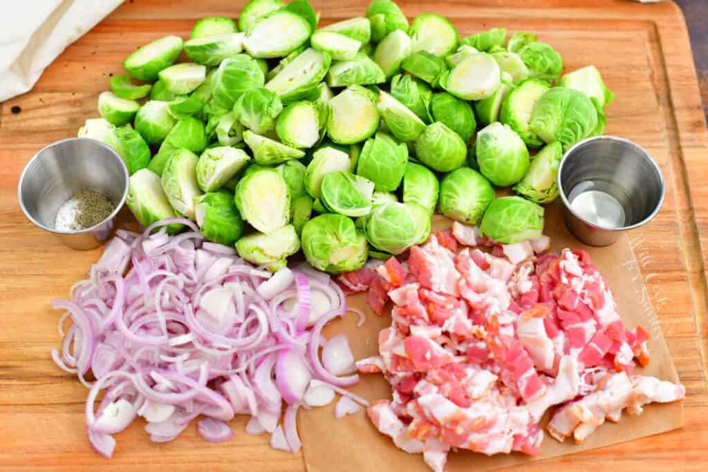 bacon, shallots and brussels sprouts on wooden cutting board