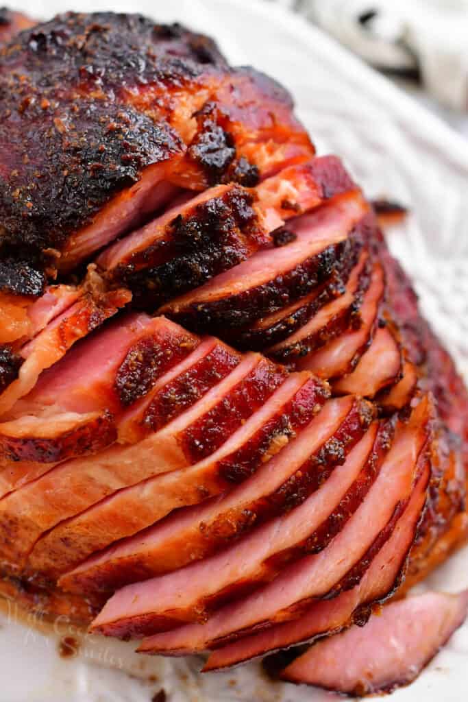 slices of glazed ham on white platter