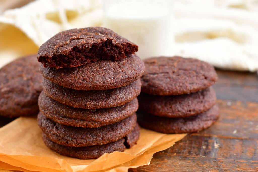 stack of soft chocolate cookies. Bite taken from the cookie on top