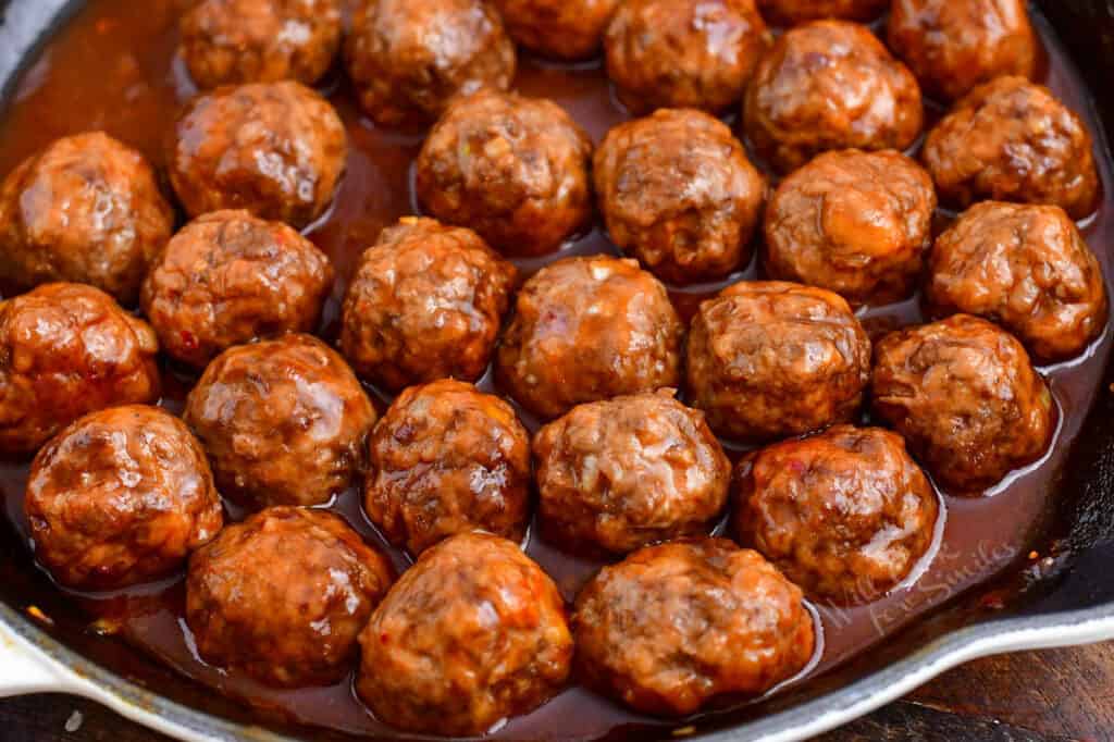 bite-sized meatballs simmering in cocktail meatball sauce