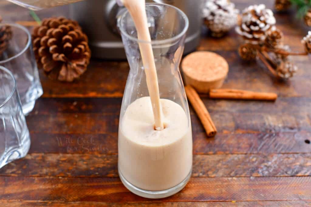 filling a glass pitcher with a Puerto Rican Christmas drink (coquito recipe)
