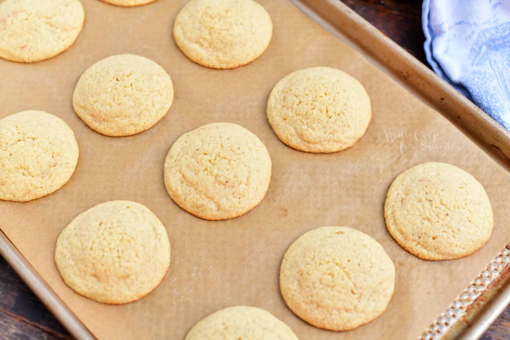 Baked eggnog cookies are 2 inches apart on a baking sheet.