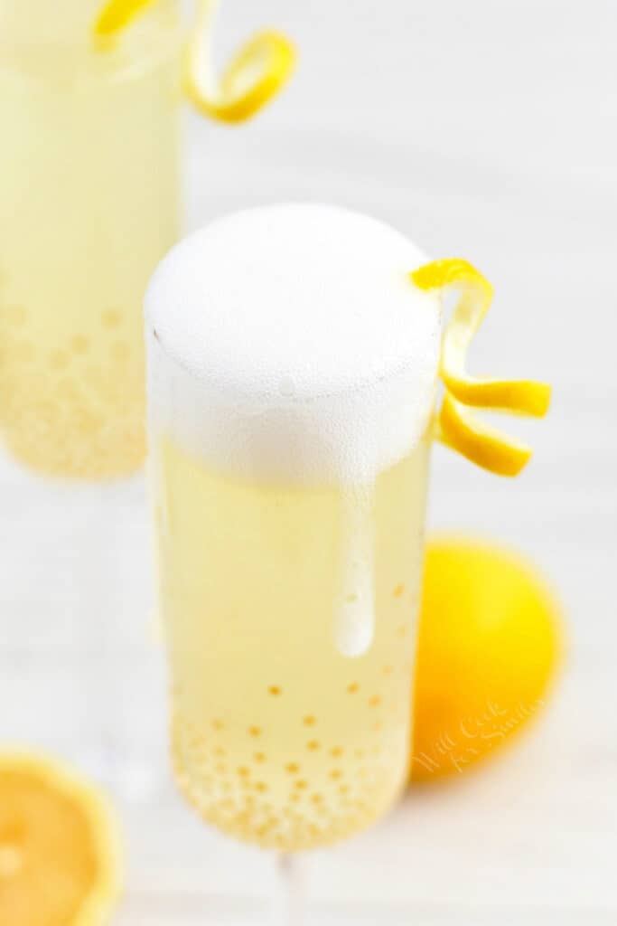 A lemon twist garnishes a glass of French 75.