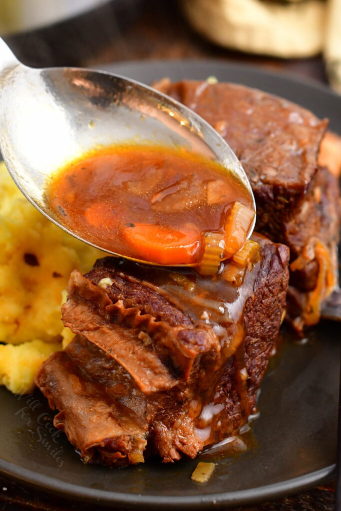 Sauce is poured onto delicious Instant Pot short ribs.
