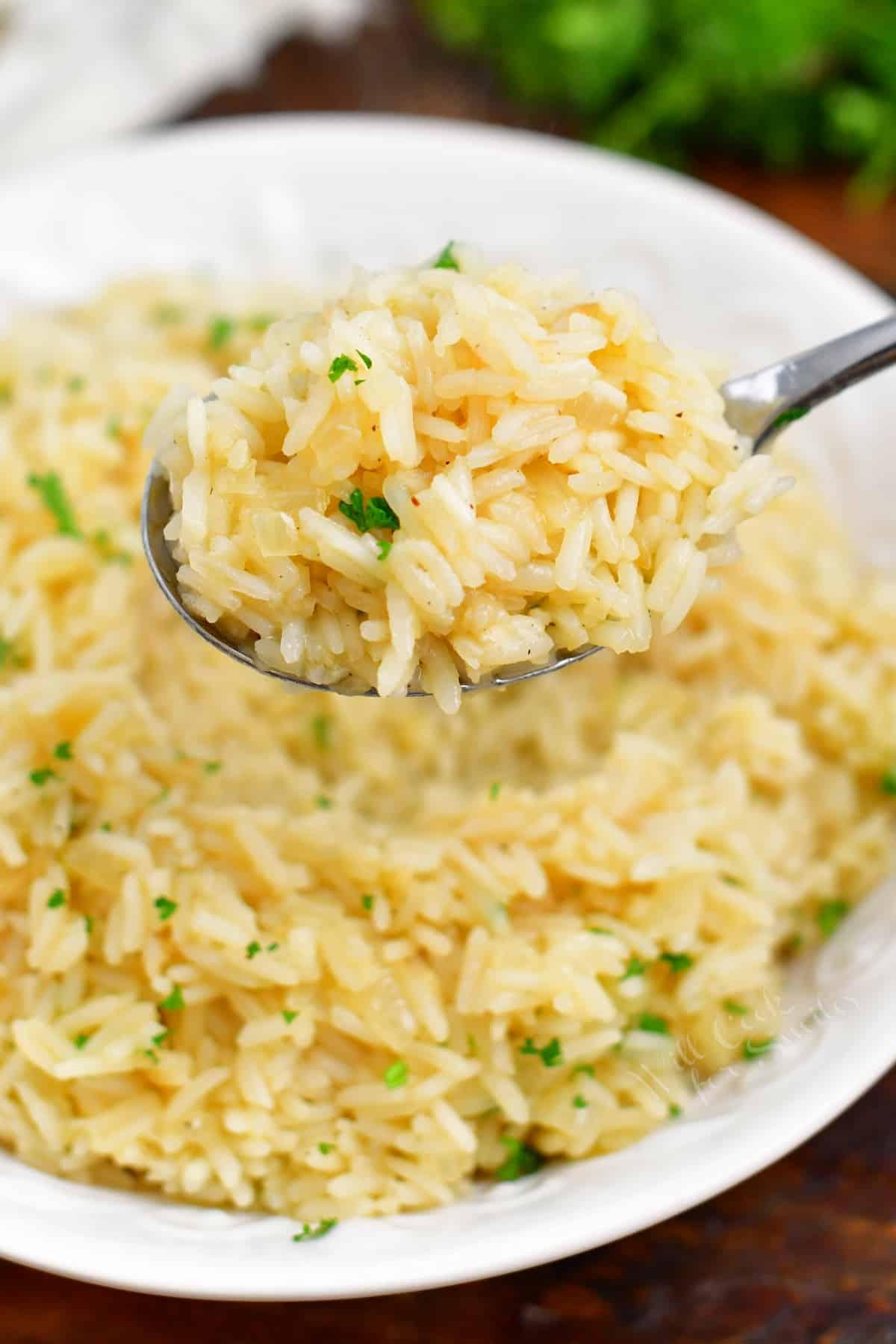 classic rice pilaf on spoon above bowl