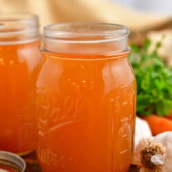 side view: homemade veggie broth in Ball canning jar