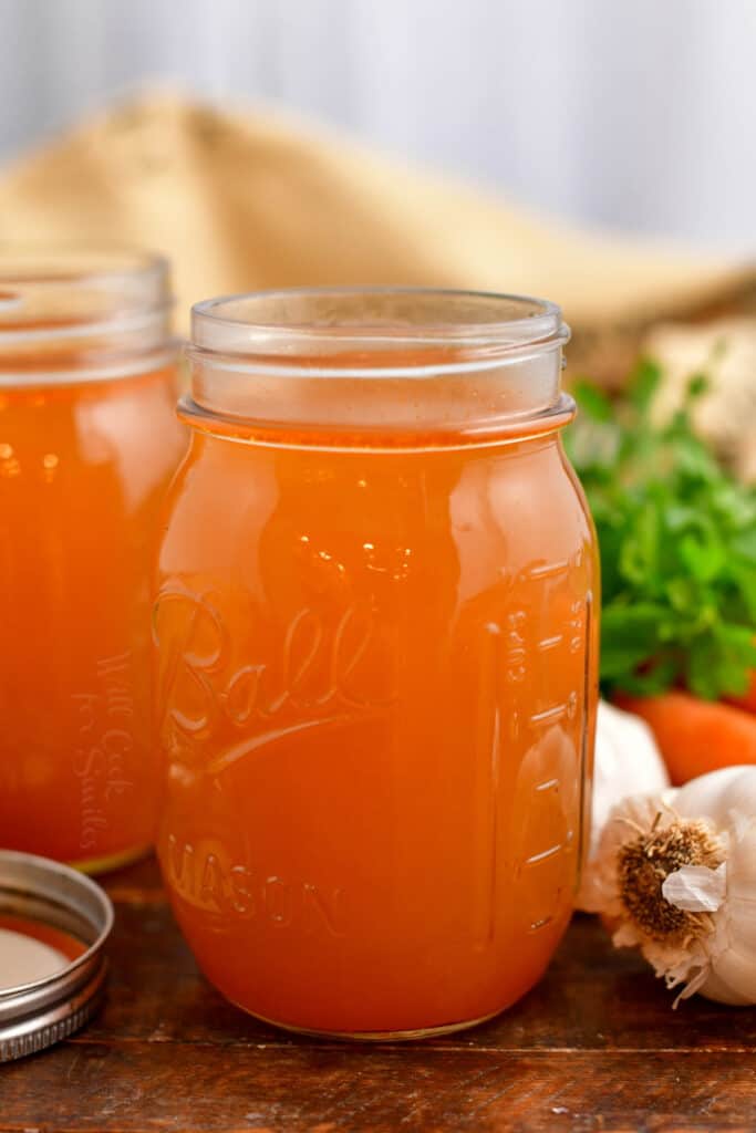 side view: homemade veggie broth in Ball canning jar