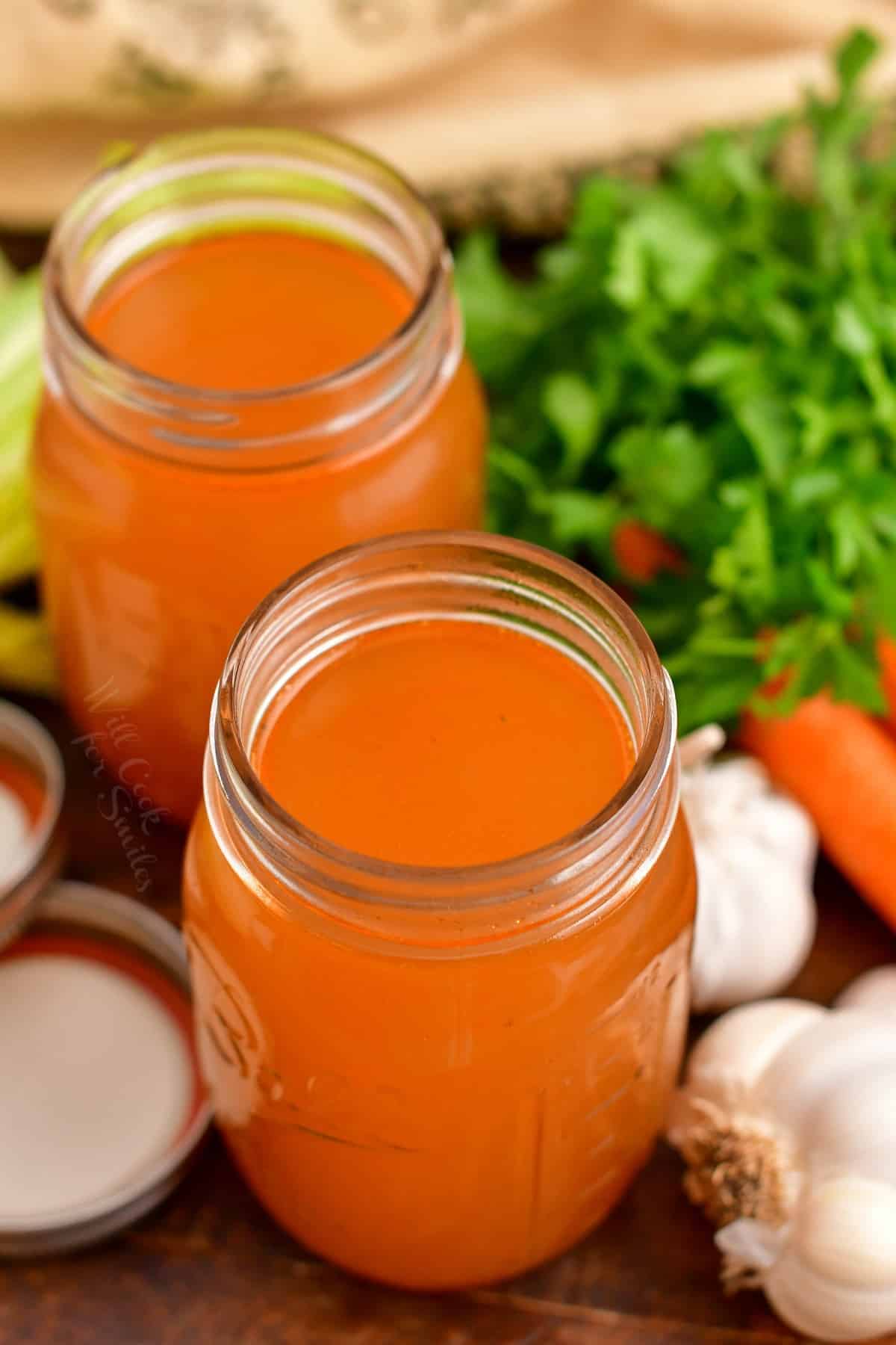 two glass jars of homemade vegetable stock