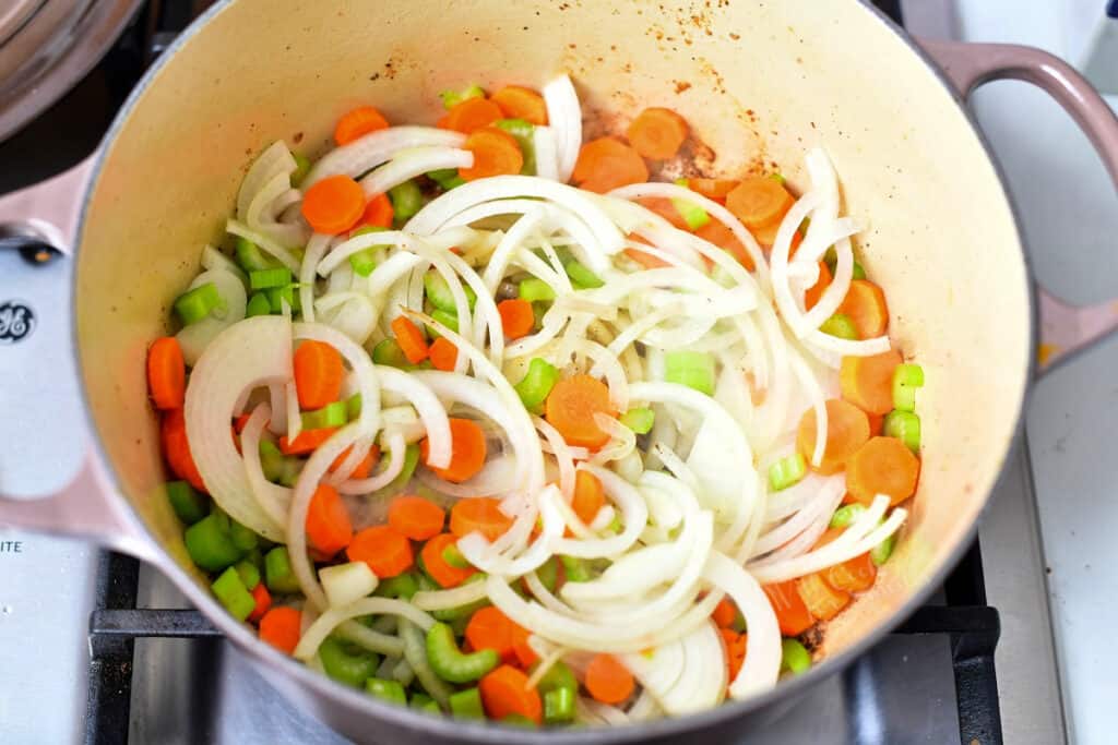overhead: diced carrots, celery, and onion in large pot on stove top