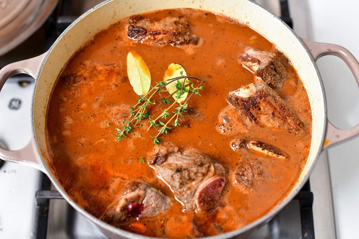 beef short ribs recipe cooking in large Dutch oven on stove top