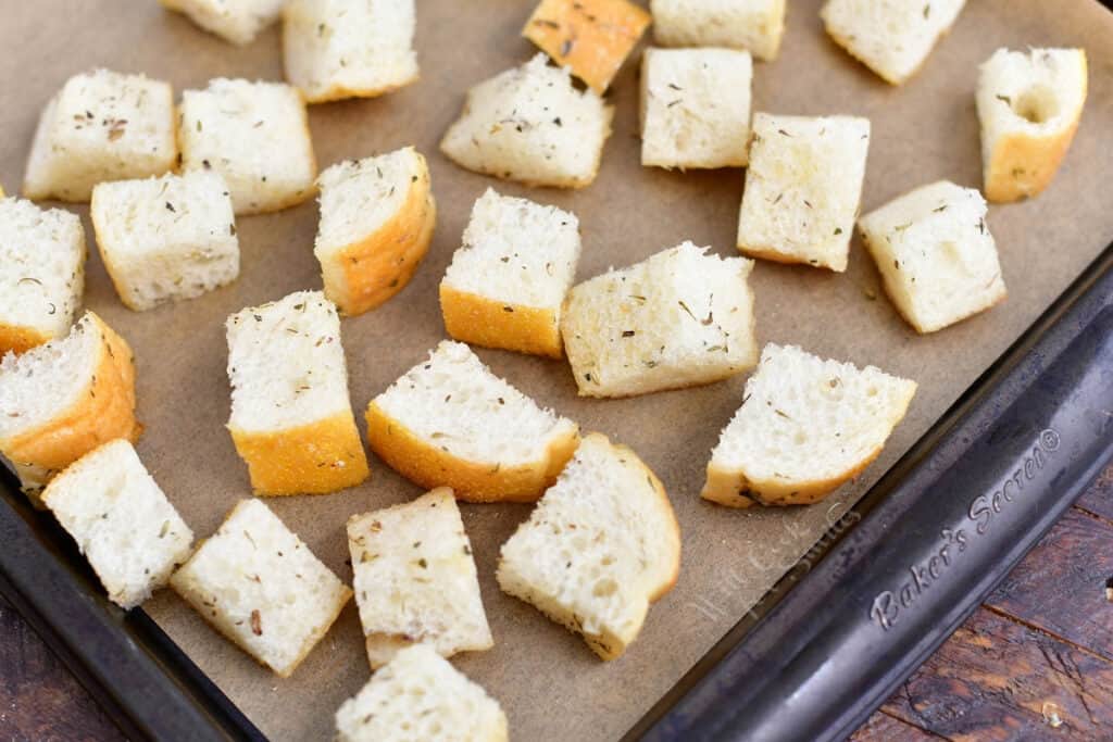 bread cubes on sheet pan for homemade croutons