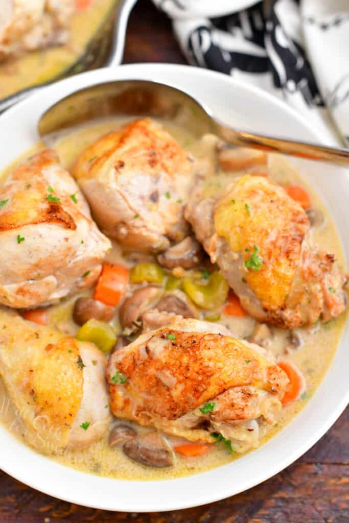 overhead: chicken fricassee in serving dish with spoon