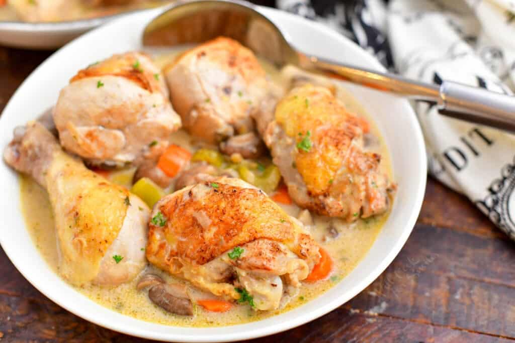 closeup: French chicken fricassee in serving bowl with spoon