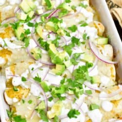 overhead: baked enchiladas verdes in a white casserole dish