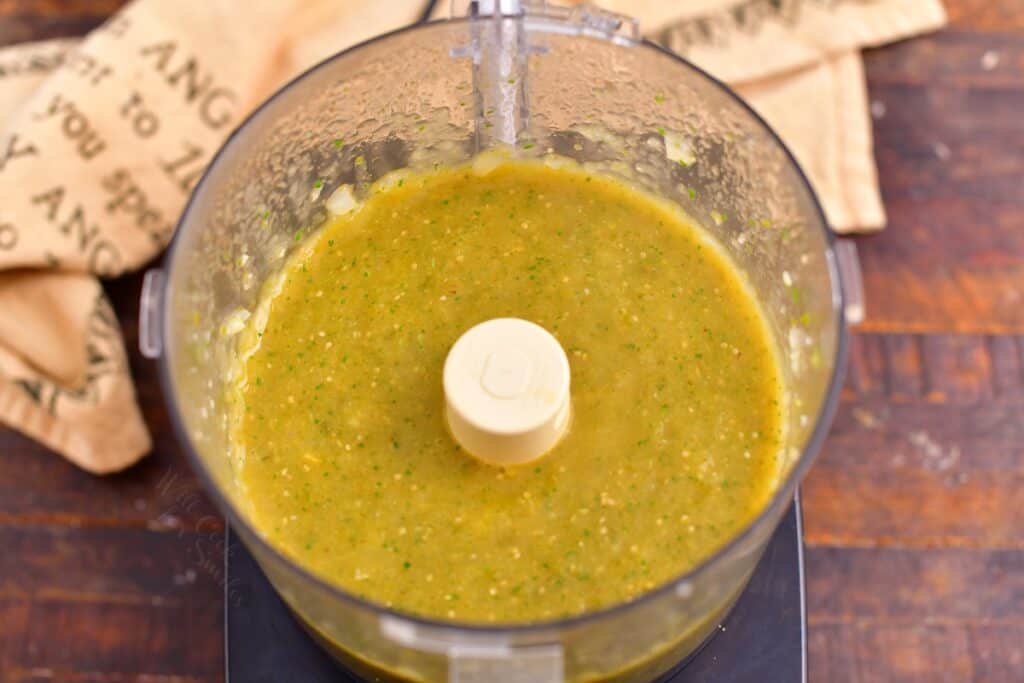 overhead: green sauce for enchiladas in a food processor