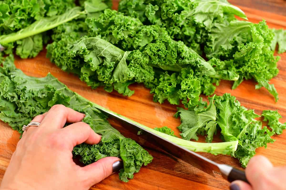 closeup: chopping kale leaves from inner ribs