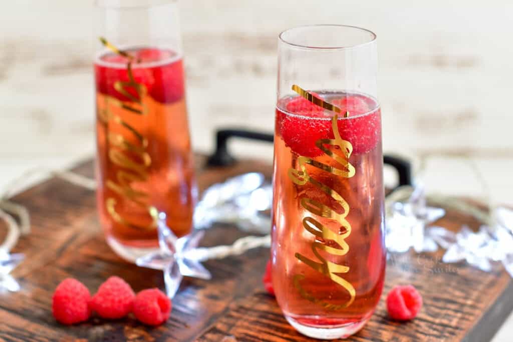 fresh raspberries floating in a Kir Royale cocktail