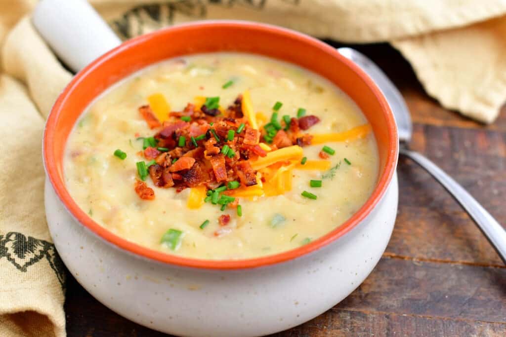 white and orange ceramic bowl filled with loaded baked potato soup
