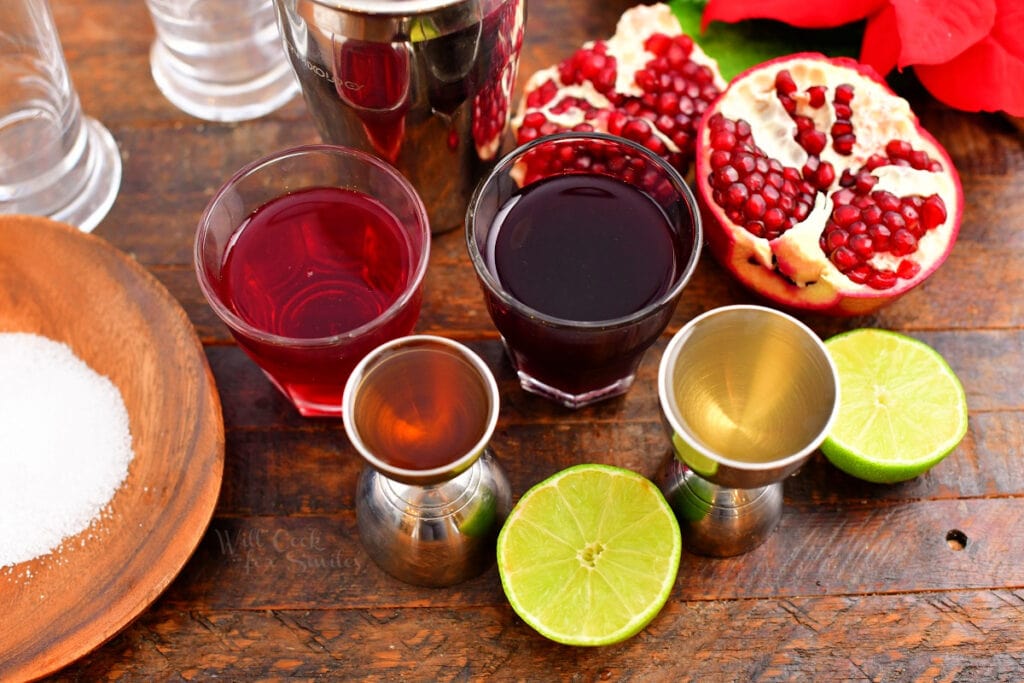 ingredients measures in glasses for the cocktail with open pomegranate next to it