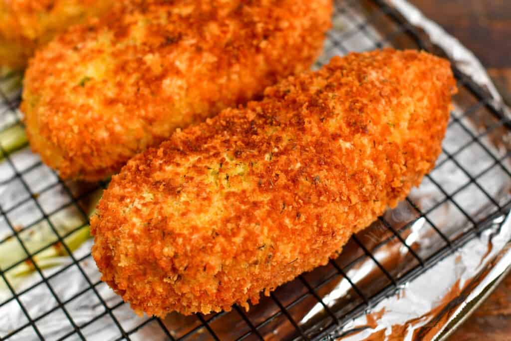 breaded and fried chicken breast on cooling rack