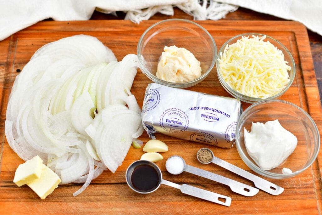 ingredients for onion dip recipe on a wooden cutting board