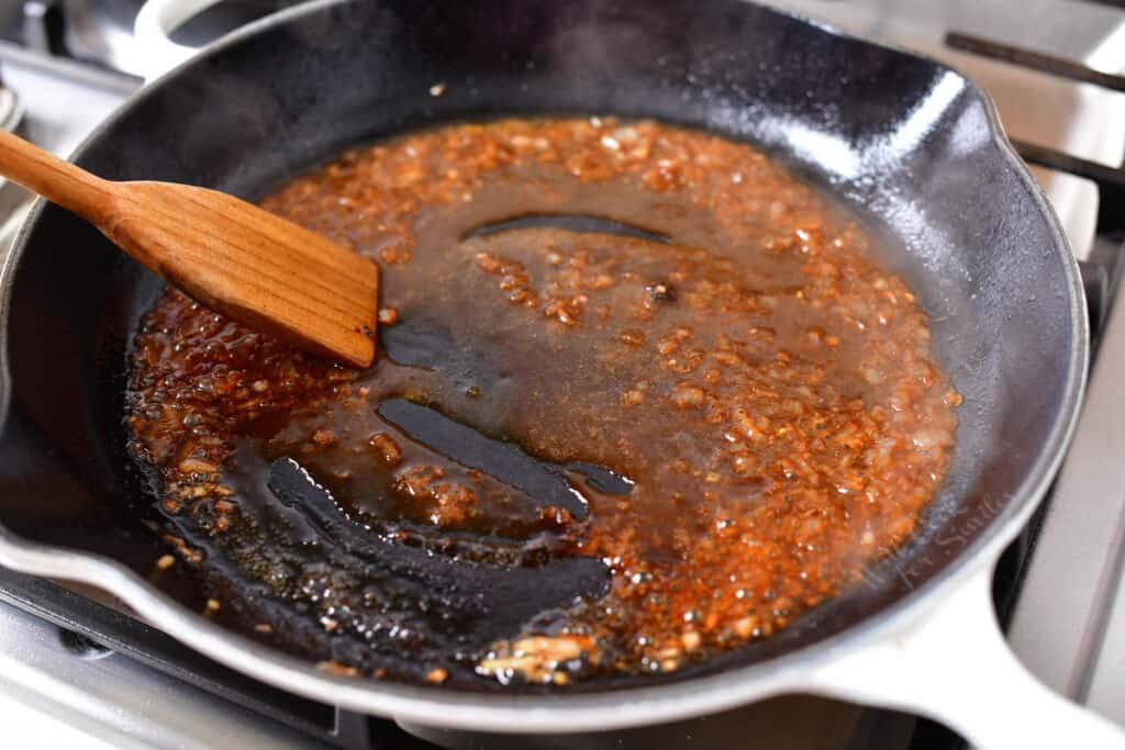 minced shallots and cognac being stirred in a pan