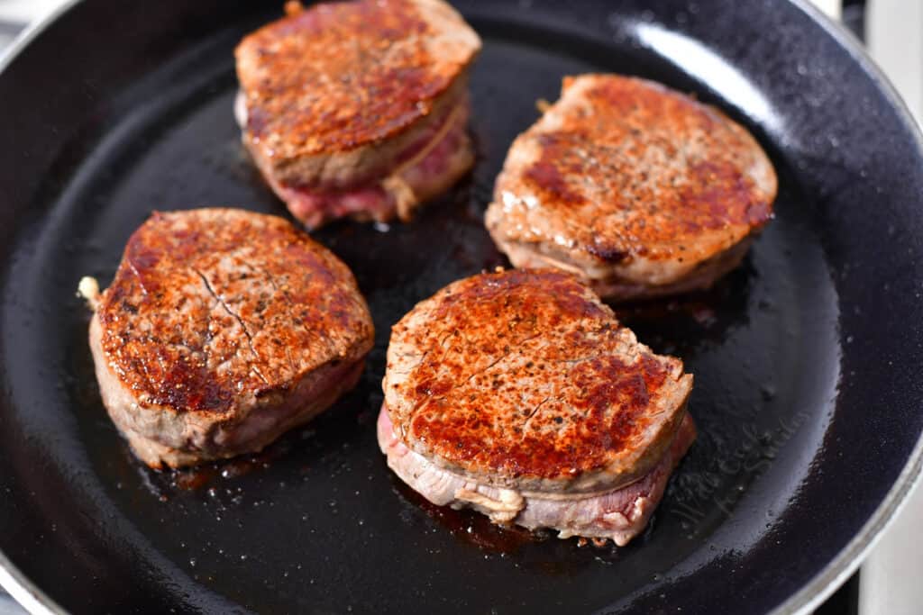 4 pan seared steaks in a skillet