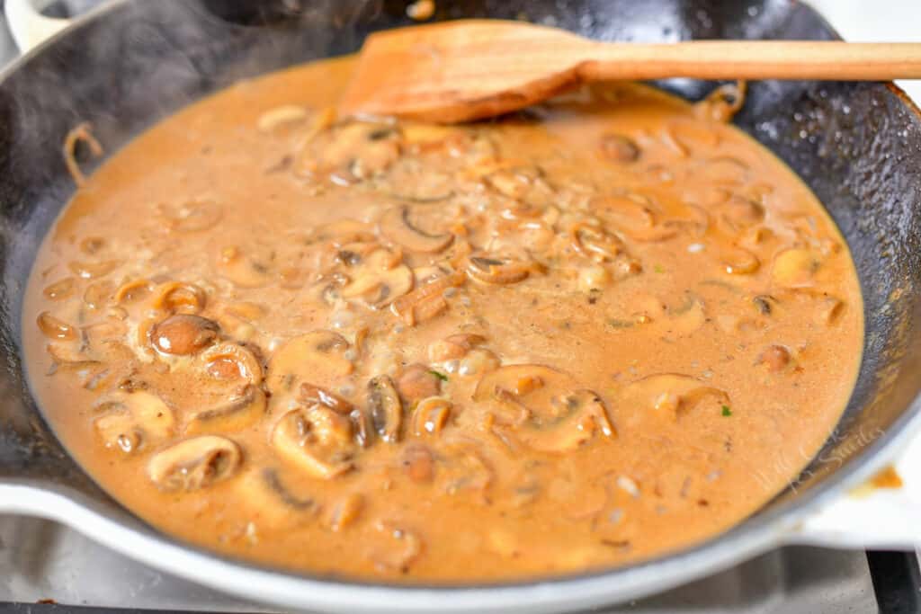 creamy mushroom sauce cooking in skillet