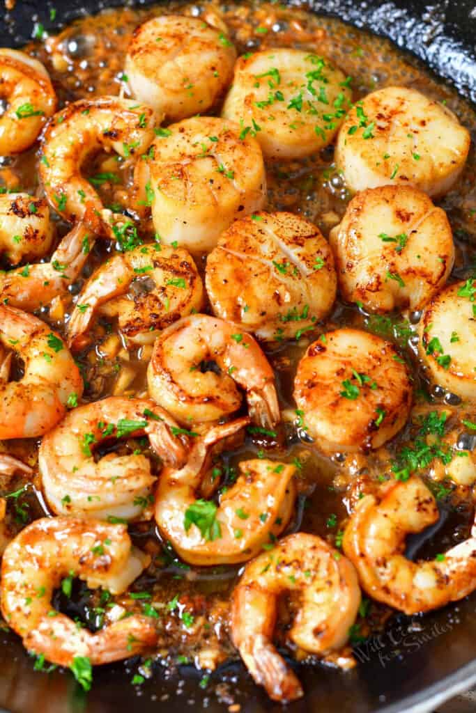 shellfish and scallops cooking in a pan for surf and turf recipe