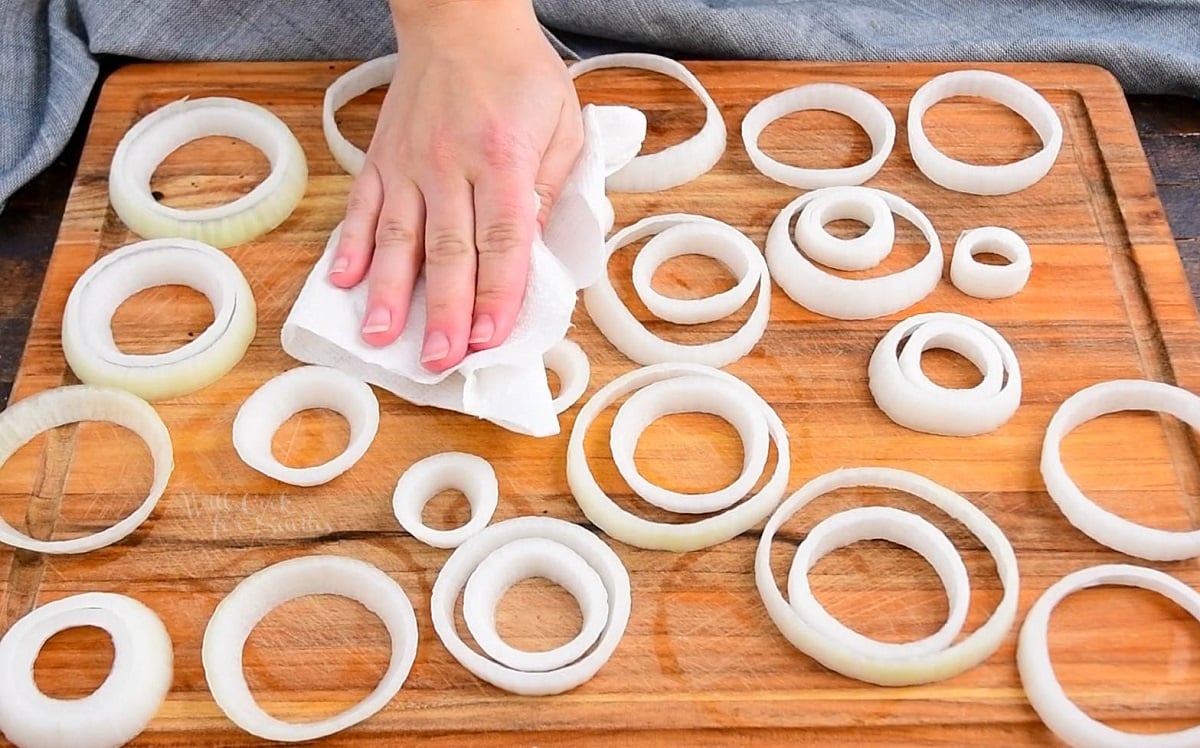 patting rings of onion with paper towel