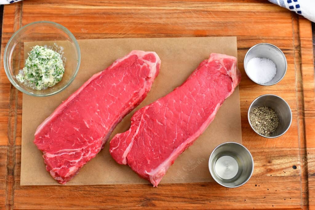 easy steak recipe ingredients: two new york strip steaks, compound butter, oil, salt and pepper