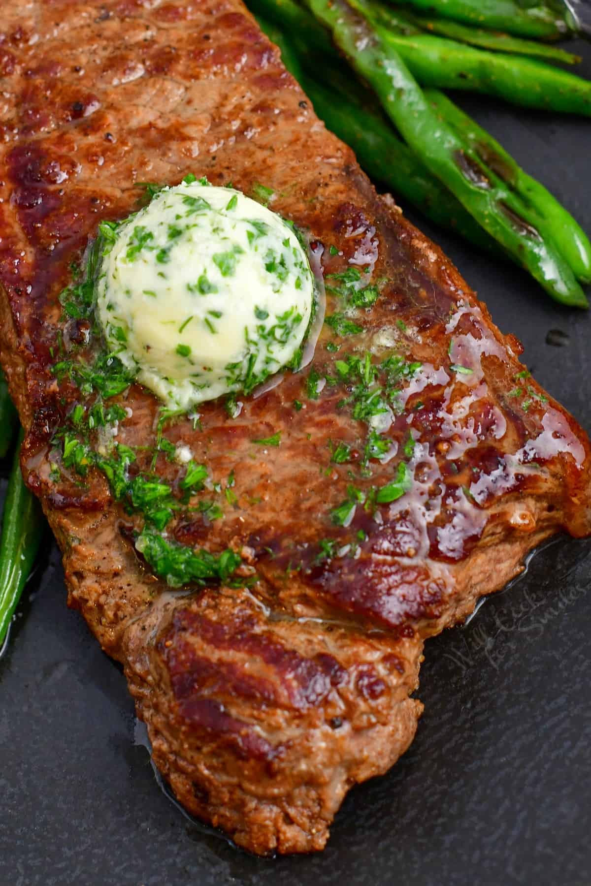 beef topped with herbed butter and roasted green beans