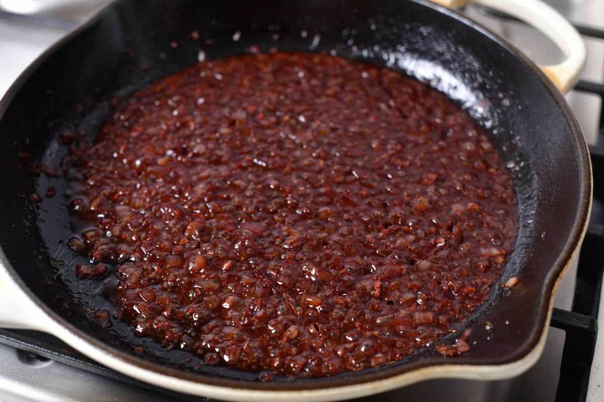 shallots, garlic and alcohol mixture simmering until reduced