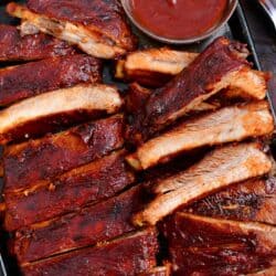 oven baked ribs with side of bbq sauce