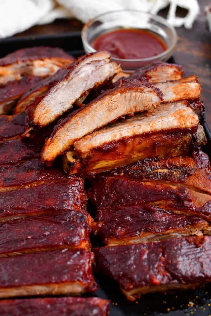 tender spare ribs on serving platter with barbecue sauce for dipping