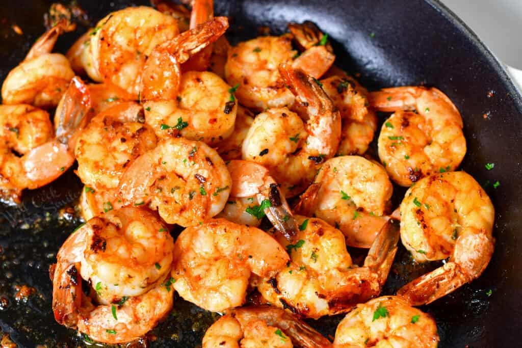 tail-on shrimp sauteeing in skillet