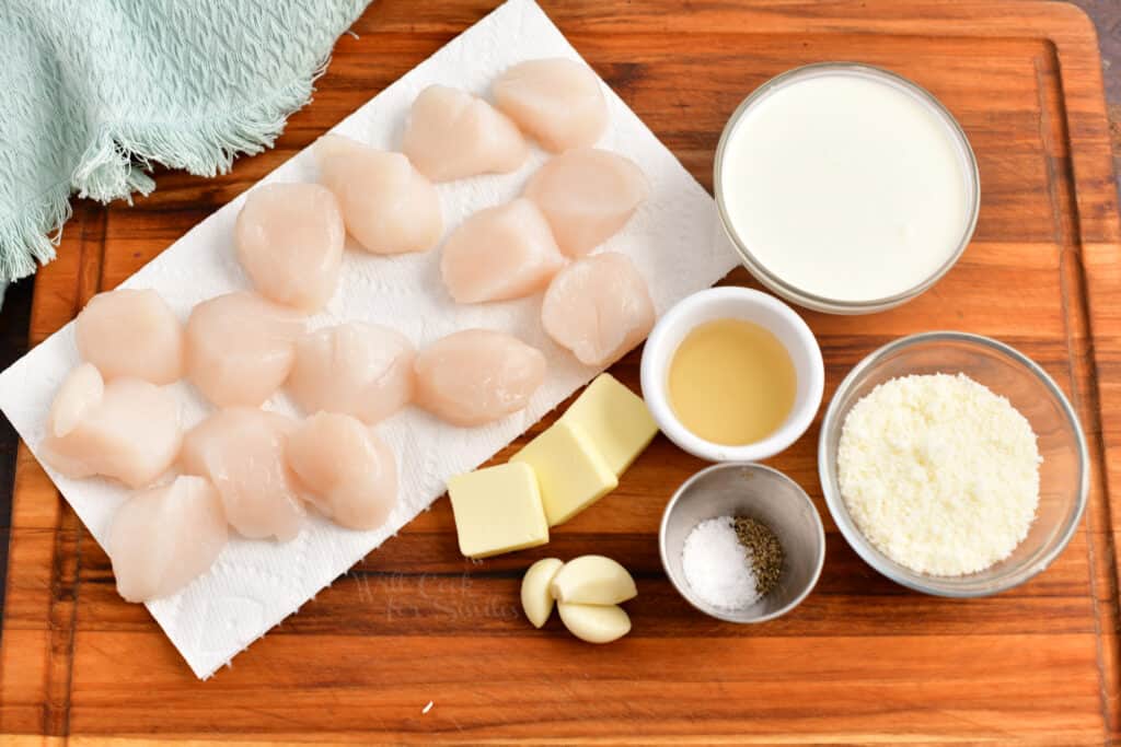 ingredients for scallop recipe on a wooden cutting board