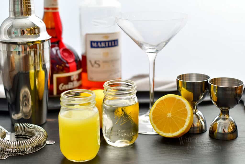 lined up ingredients for the Sidecar on black wooden board