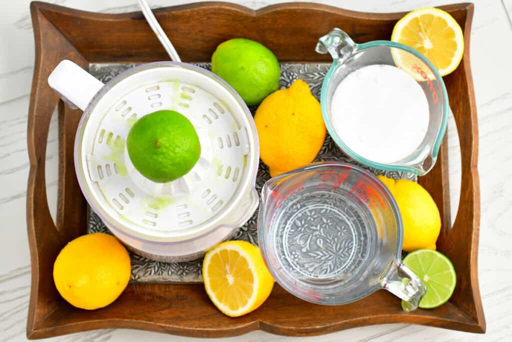 ingredients for sweet and sour mix on a wooden tray