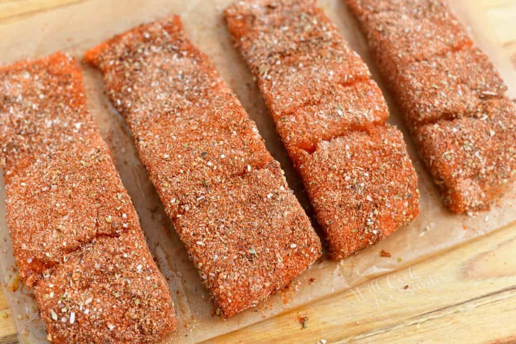 uncooked salmon fillets coated in blackening seasoning