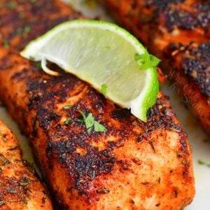 closeup of blackened salmon filet with a lime wedge