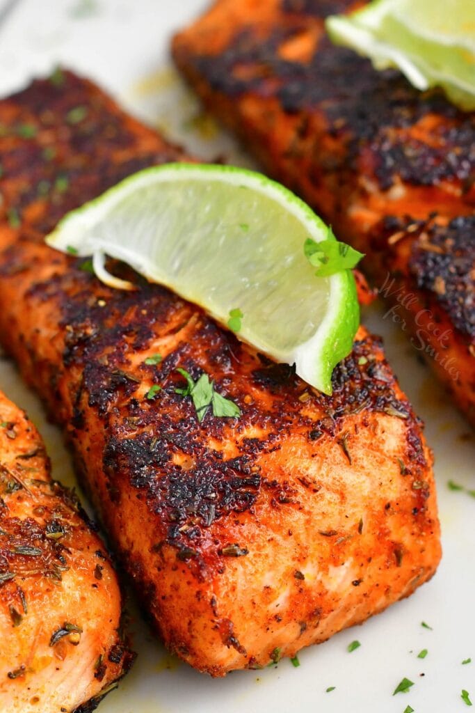 closeup of blackened salmon filet with a lime wedge