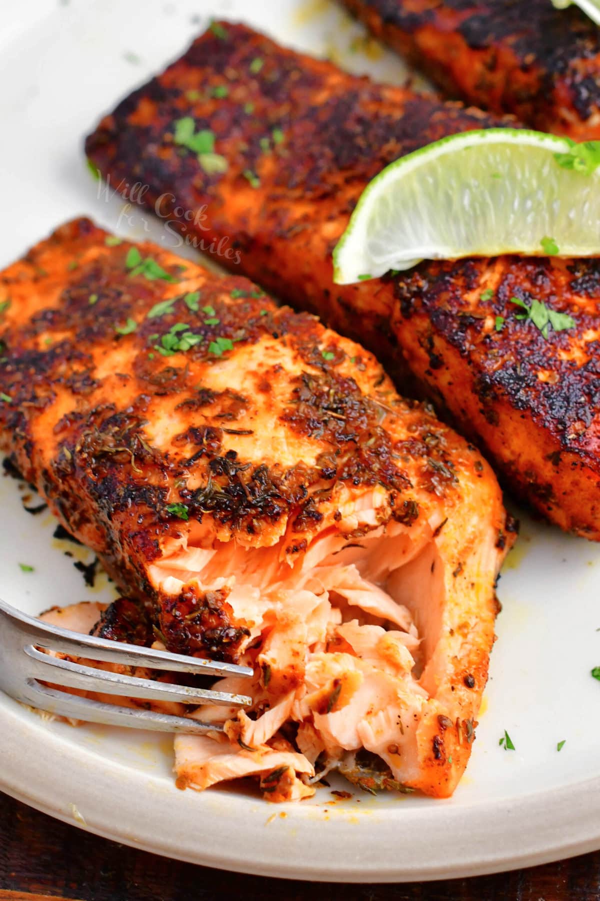 salmon with some of the meat flaked off with a fork