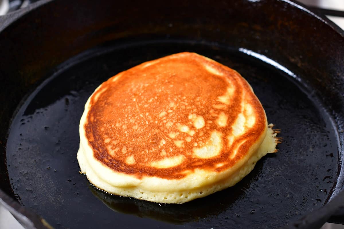 A cooked pancake is in the griddle. 