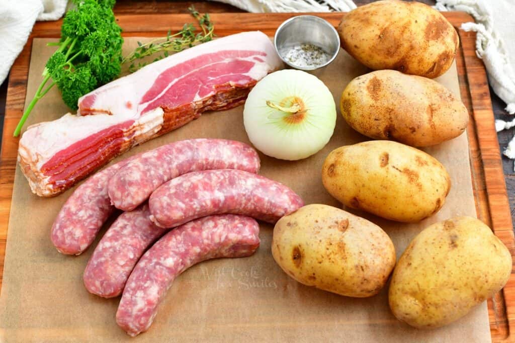 The ingredients for Dublin Coddle are placed on a wooden cutting board.