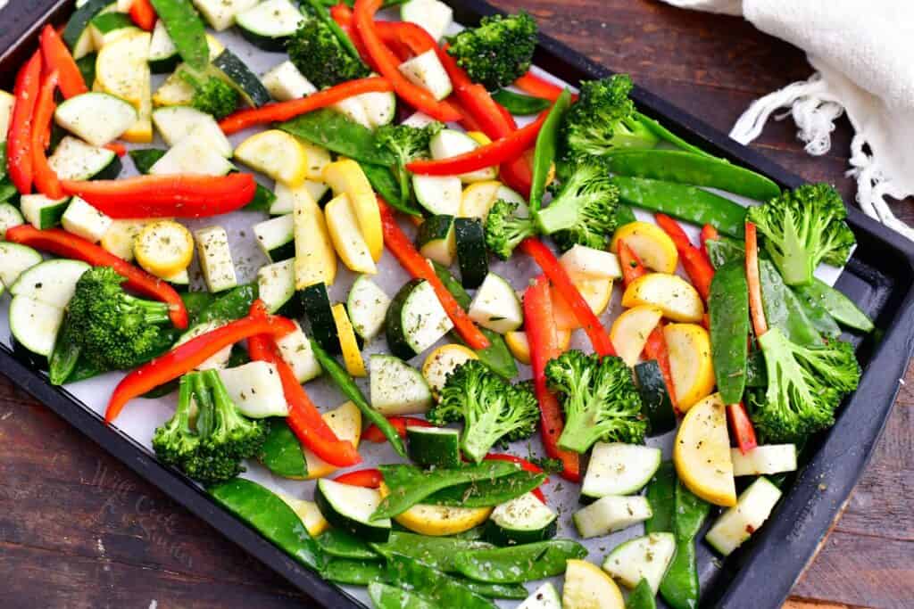 Vegetables are on a baking sheet. 