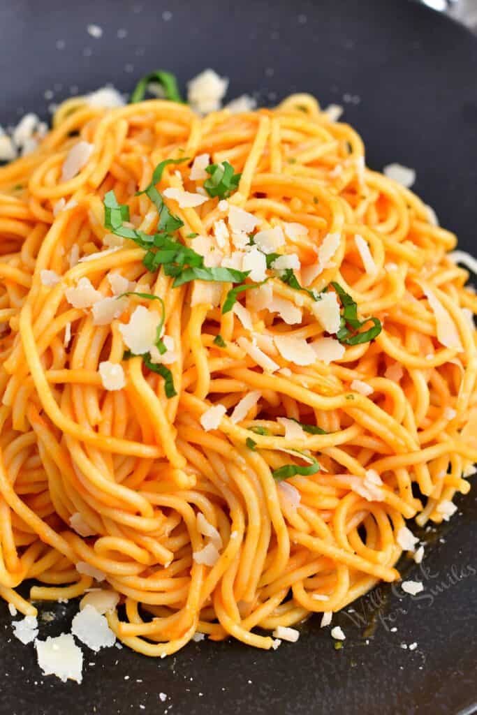 spaghetti tossed in Pomodoro sauce on a plate with Parmesan