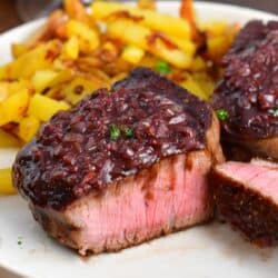 closeup of sliced tenderloin steak with sauce on top